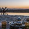 closeup shot of a typical Moroccan mint tea set on the table in  Agafay desert, Marrakech
