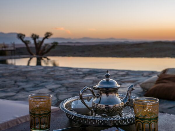 closeup shot of a typical Moroccan mint tea set on the table in  Agafay desert, Marrakech